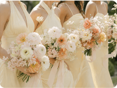 Bridesmaids in butter yellow holding pastel bouquets